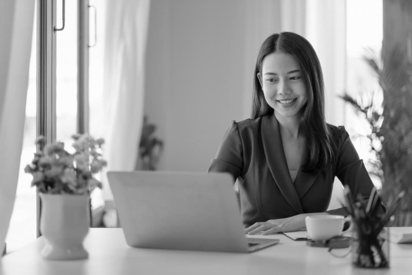 Students collaborating on financial analysis project using laptops and spreadsheets